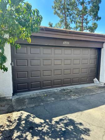 Residential garage door on a driveway in Bell Gardens, California photographed during garage door repair